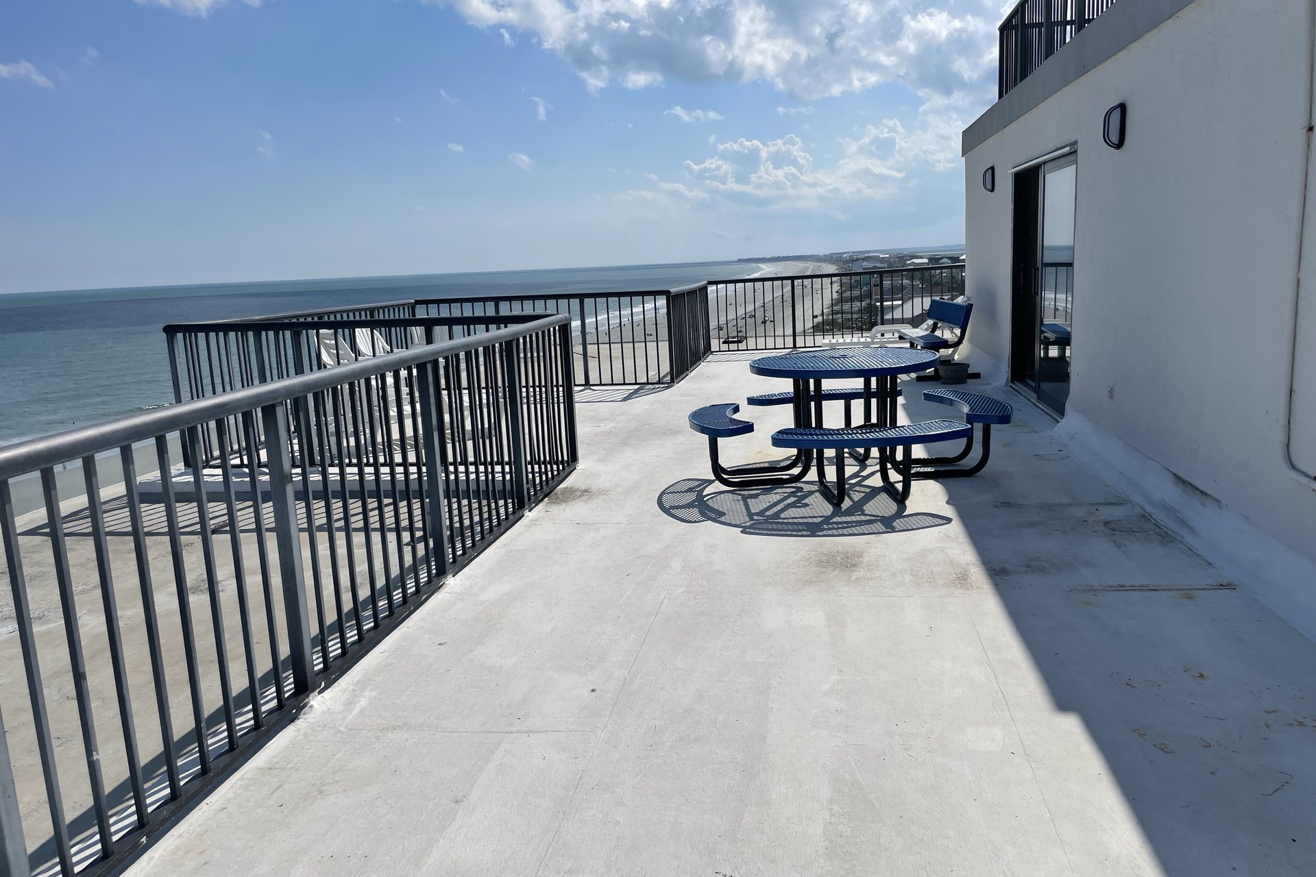 Private rooftop deck with picnic tables overlooking the Atlantic